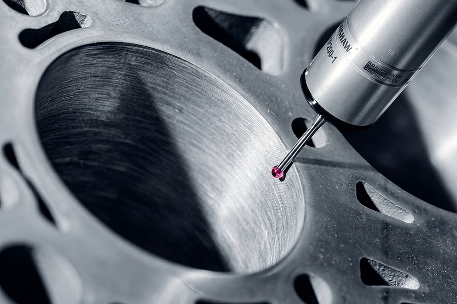 CMM probe measuring a precision metal part