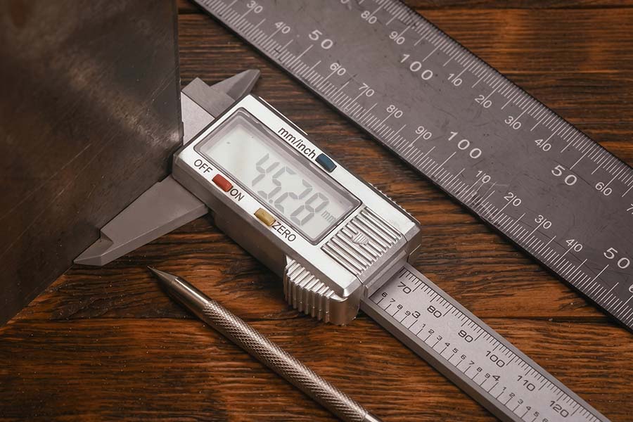 Digital caliper measuring sheet metal gauge