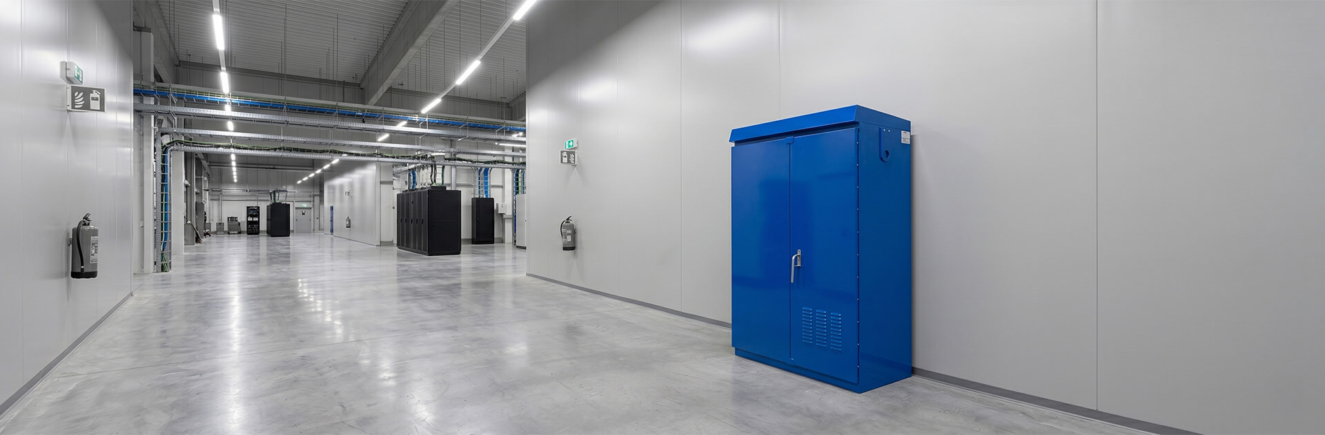 Blue traffic control enclosure with sloped roof and ventilation louvers