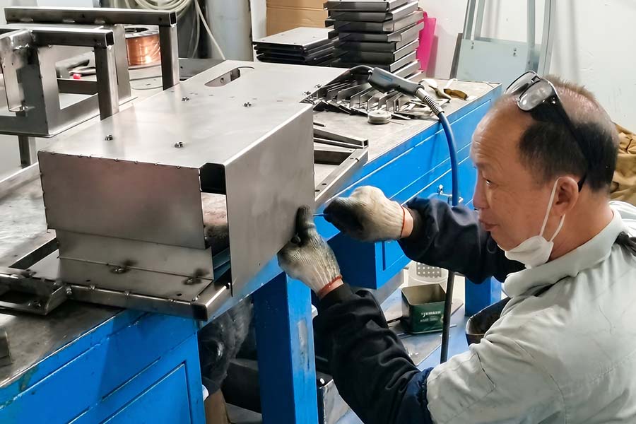 Experienced technician inspecting a first article sheet metal prototype