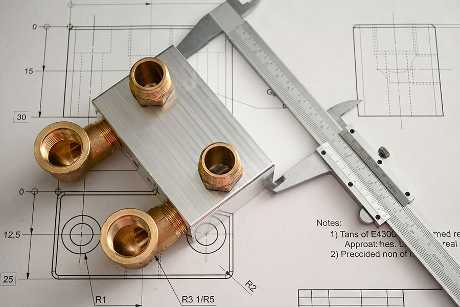 Machined metal part and caliper on an engineering drawing