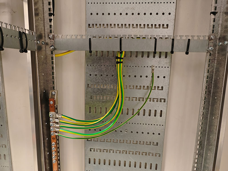 Modular perforated mounting plate inside industrial electrical enclosure
