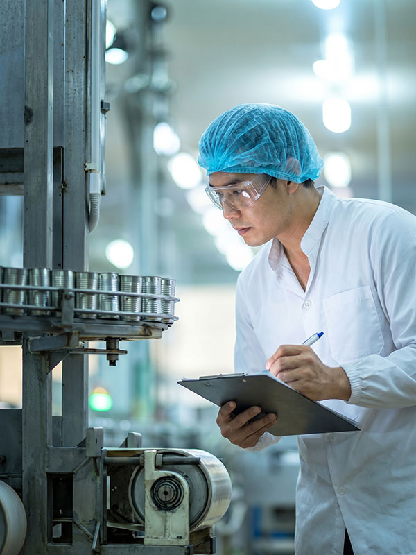 Quality engineers inspecting a coated metal test panel