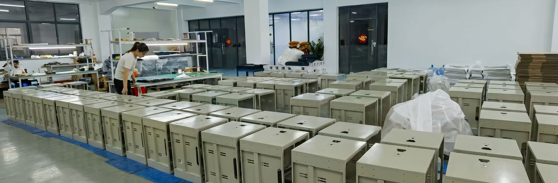 Rows of fabricated metal cabinets in a clean assembly area