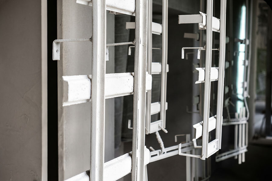Tubular metal parts suspended on an industrial racking line