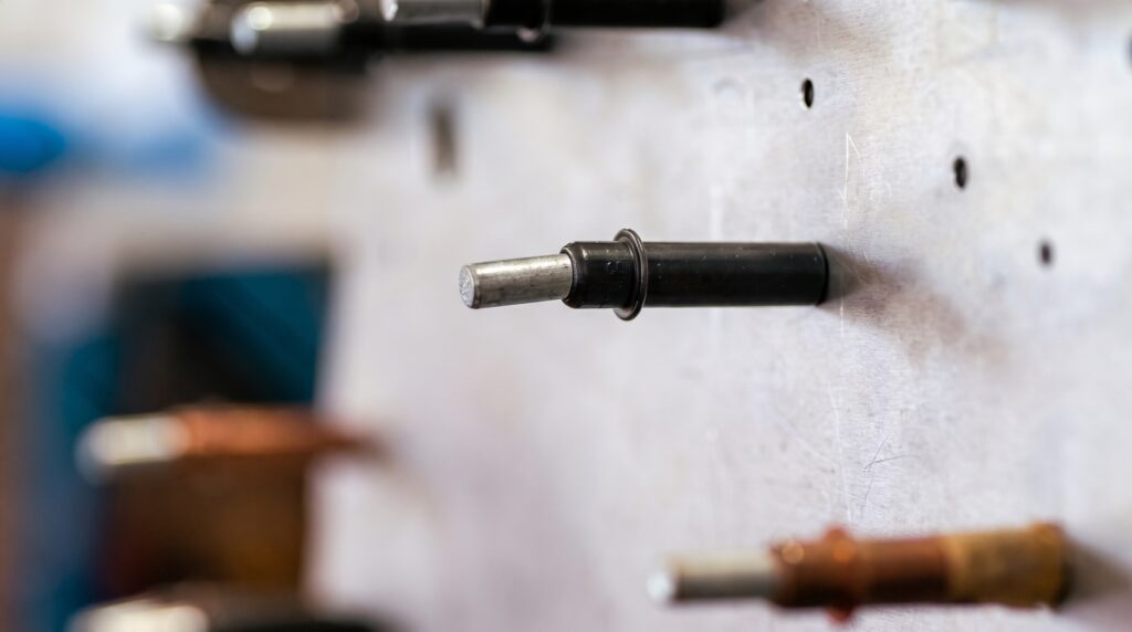 Close-up of a Cleco fastener in metal
