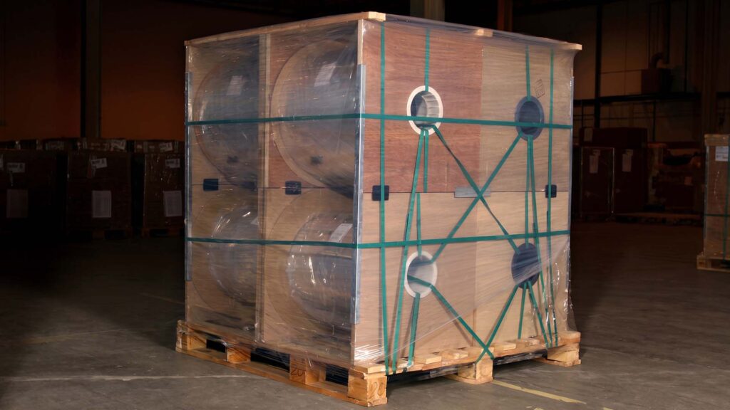 Industrial metal parts packed on pallet with film