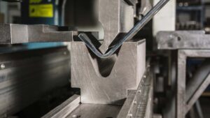 Press brake machine bending sheet metal in V-die