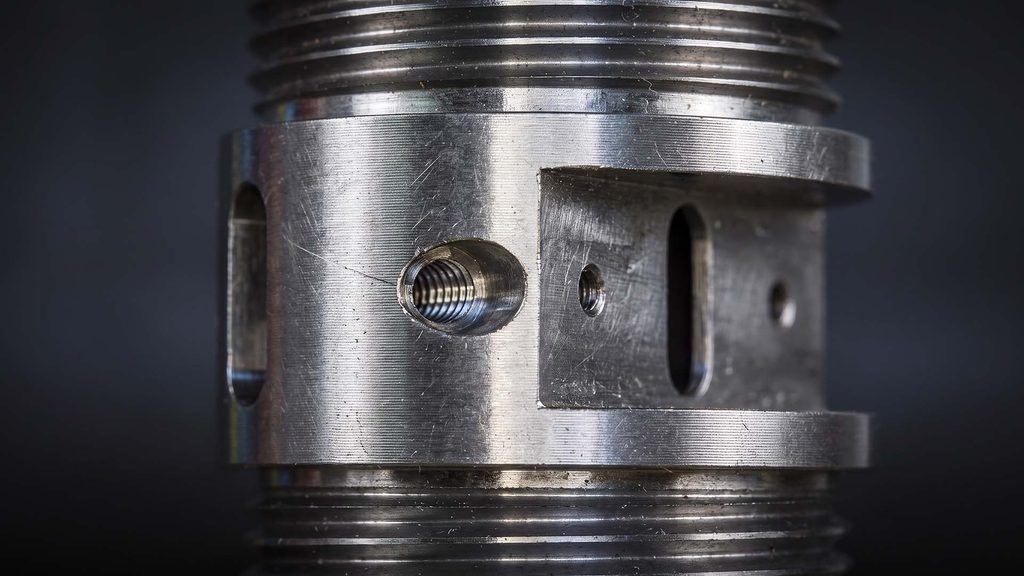 Close-up of threaded blind hole in plated metal