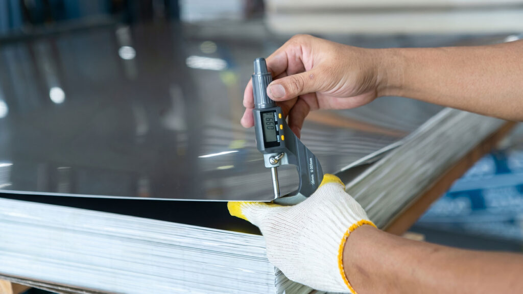 Digital micrometer measuring aluminum sheet thickness