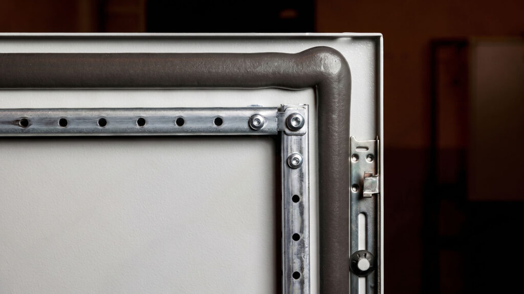 Electrical enclosure door with rubber compression seal