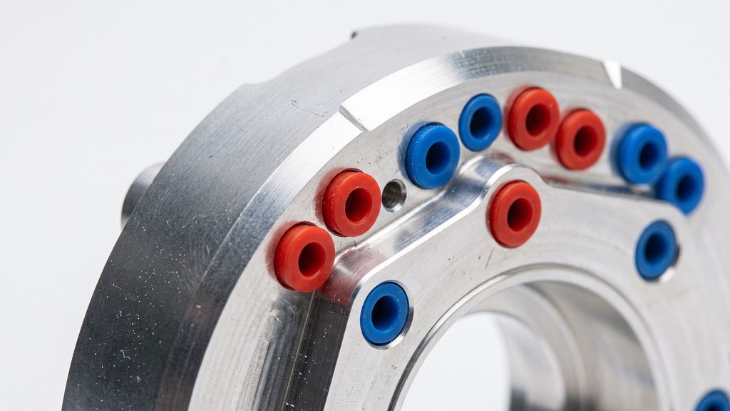 Metal part with silicone masking plugs