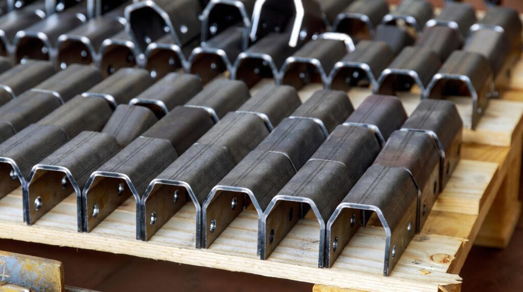 Nested sheet metal brackets stacked for shipping