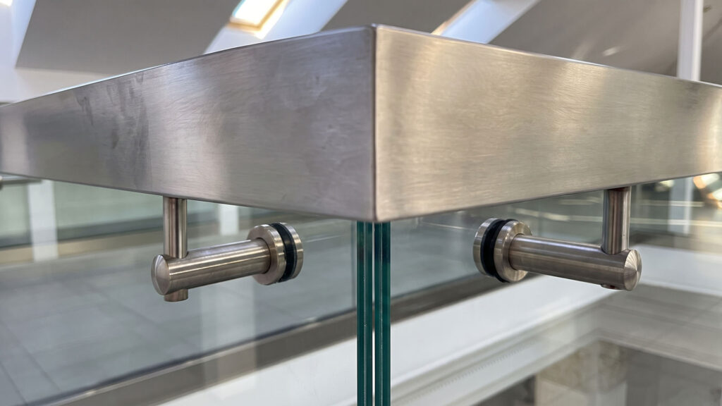 Seamless brushed steel fabrication corner joint close up