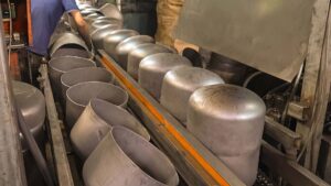 Seamless deep drawn metal shells on production line