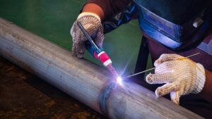 Welder uses TIG torch for detailed aluminum welding