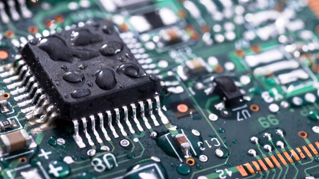 Wet circuit board showing water ingress damage