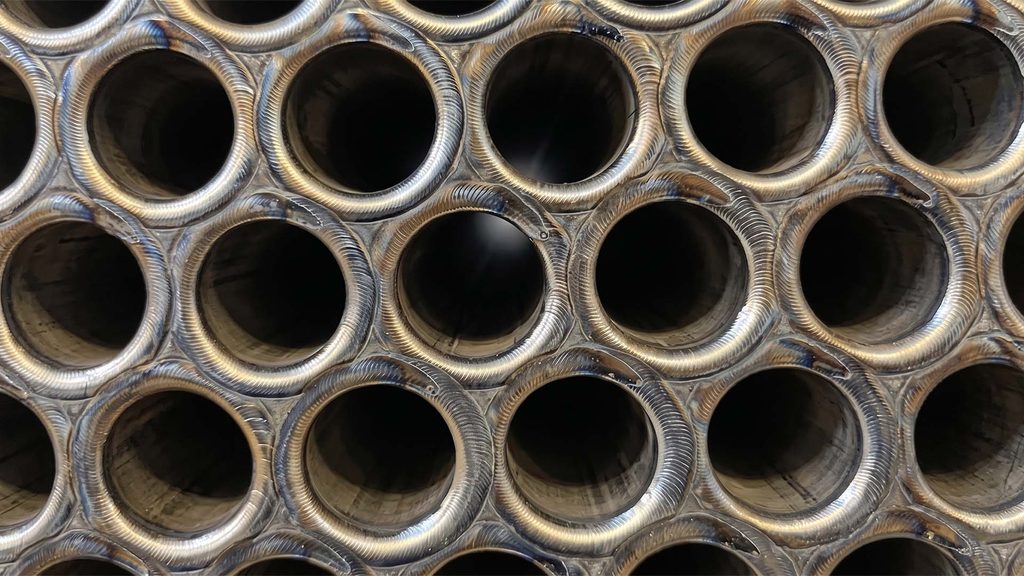 Close-up of welded metal tubes with heat tint